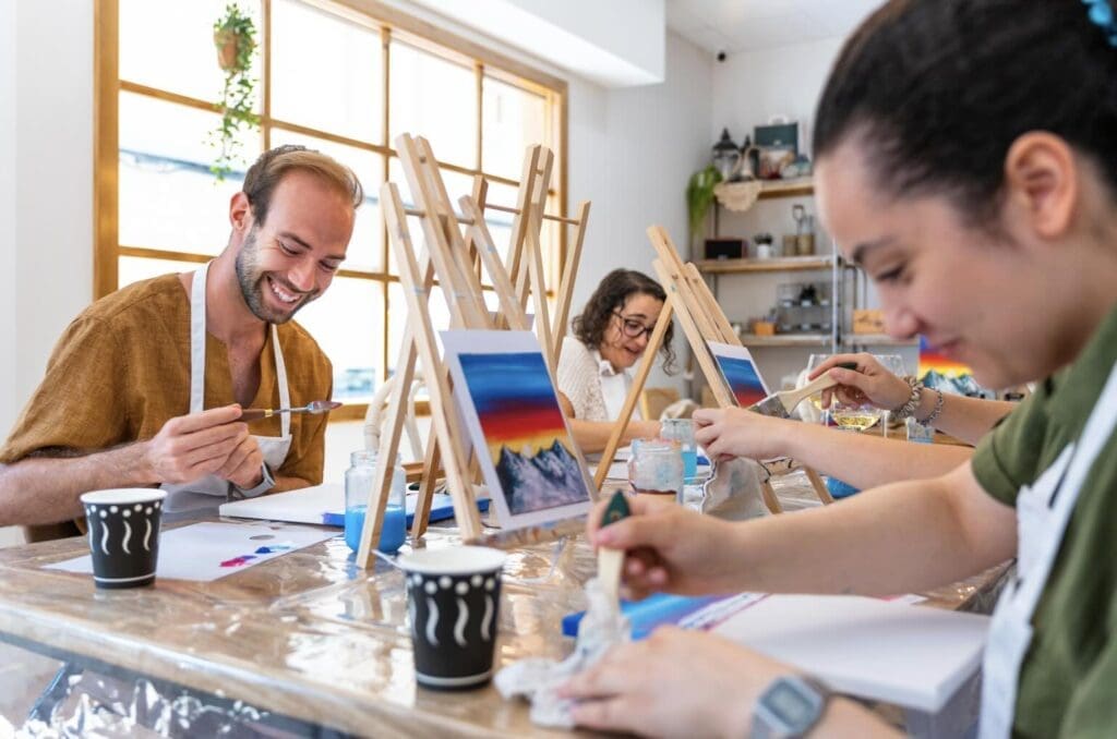 A group of artist painting on their canvas